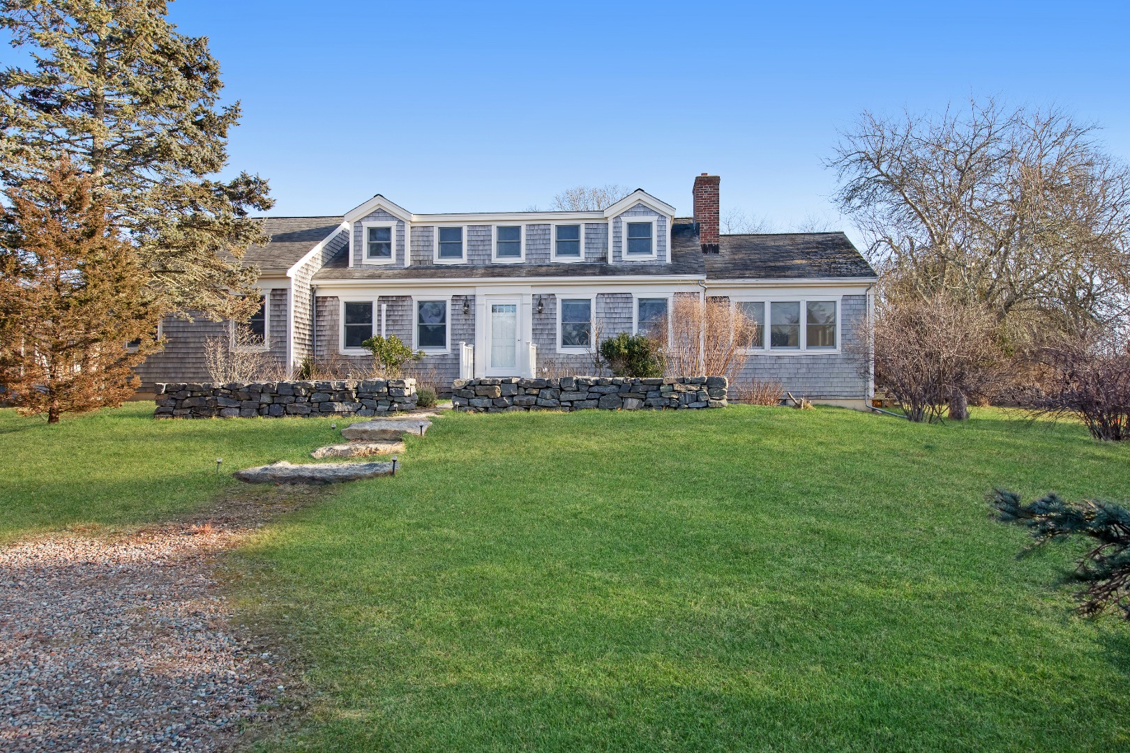 276 S Road Chilmark, MA 02535 - Photo 1 of 39 a front view of a house with a garden and plants