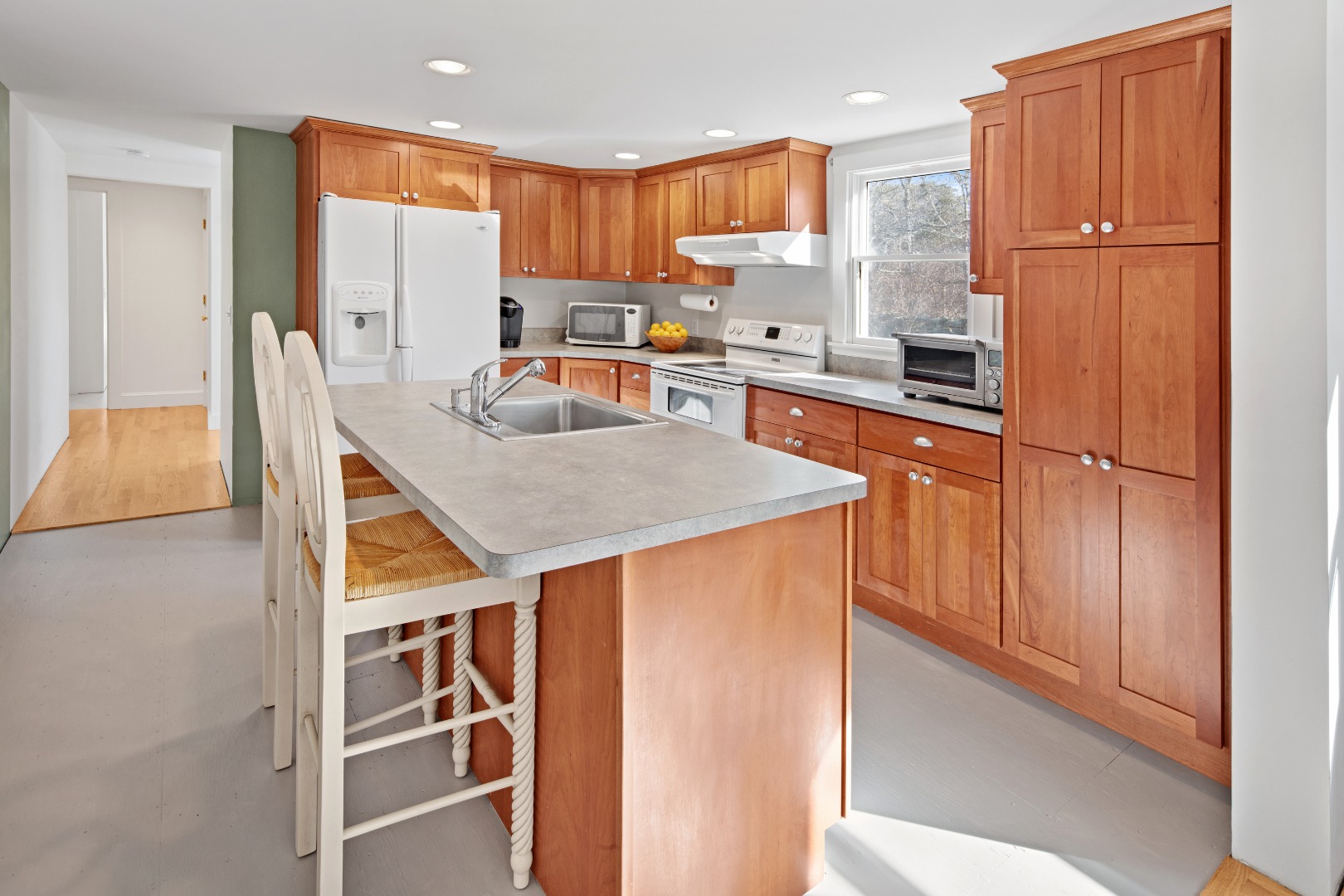 276 S Road Chilmark, MA 02535 - Photo 12 of 39 a kitchen with stainless steel appliances granite countertop a refrigerator a stove and a sink with wooden floor