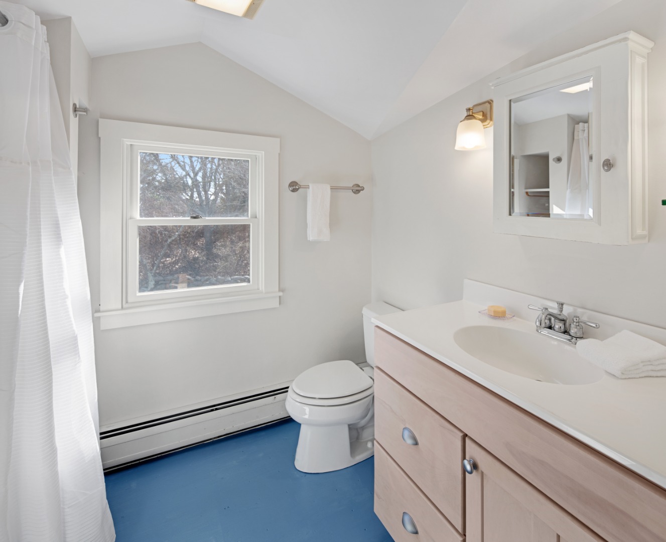 276 S Road Chilmark, MA 02535 - Photo 30 of 39 a bathroom with a granite countertop toilet a sink and a mirror