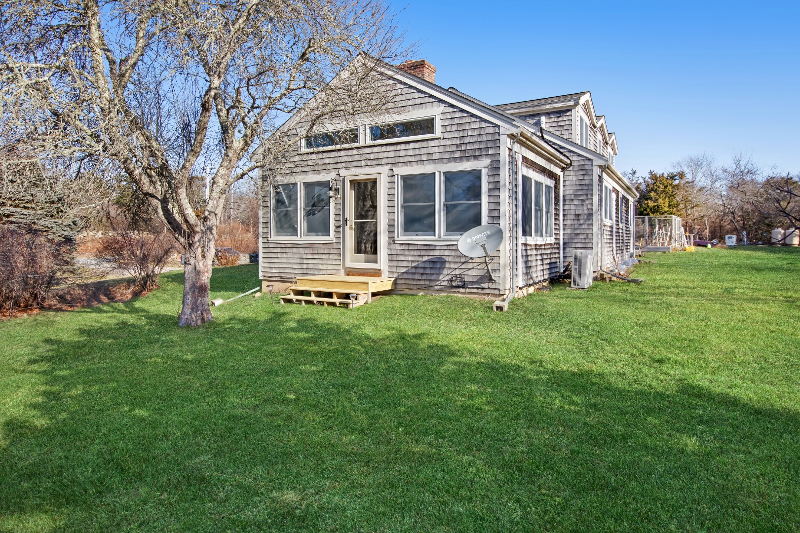 276 S Road Chilmark, MA 02535 - Photo 4 of 39 a front view of a house with a yard