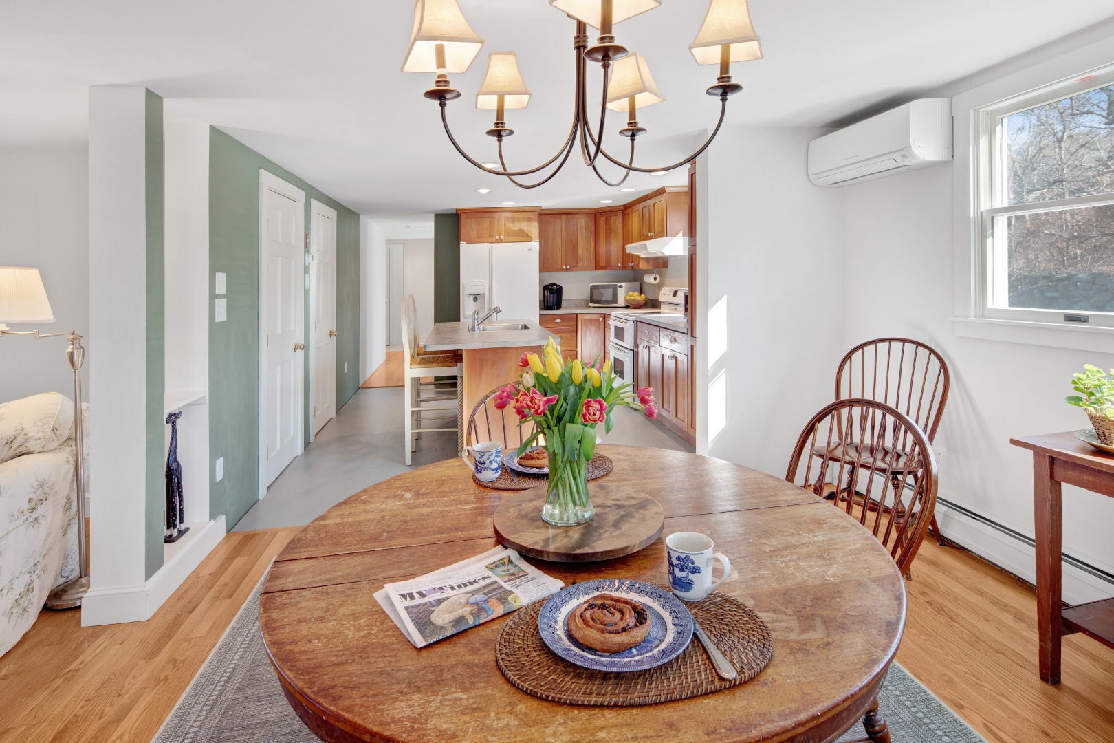 276 S Road Chilmark, MA 02535 - Photo 9 of 39 a view of a dining room with furniture a chandelier and wooden floor