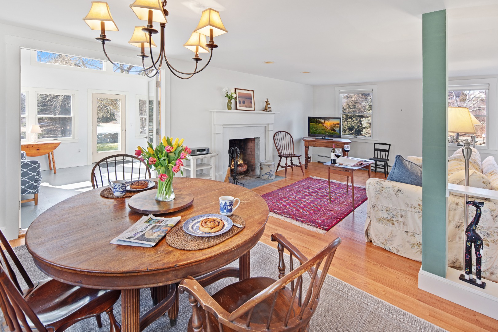 276 S Road Chilmark, MA 02535 - Photo 10 of 39 a view of a dining room with furniture a chandelier and wooden floor
