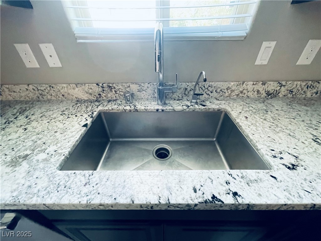 930 Bayberry Ridge Street Henderson, NV 89052 - Photo 14 of 40 Kitchen view of light stone countertops and a sink
