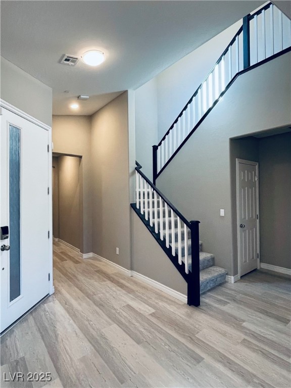 930 Bayberry Ridge Street Henderson, NV 89052 - Photo 15 of 40 Foyer with light wood-style flooring and stairway
