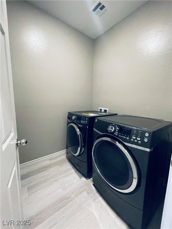 930 Bayberry Ridge Street Henderson, NV 89052 - Photo 24 of 40 Washroom with wood finished floors and washer and dryer