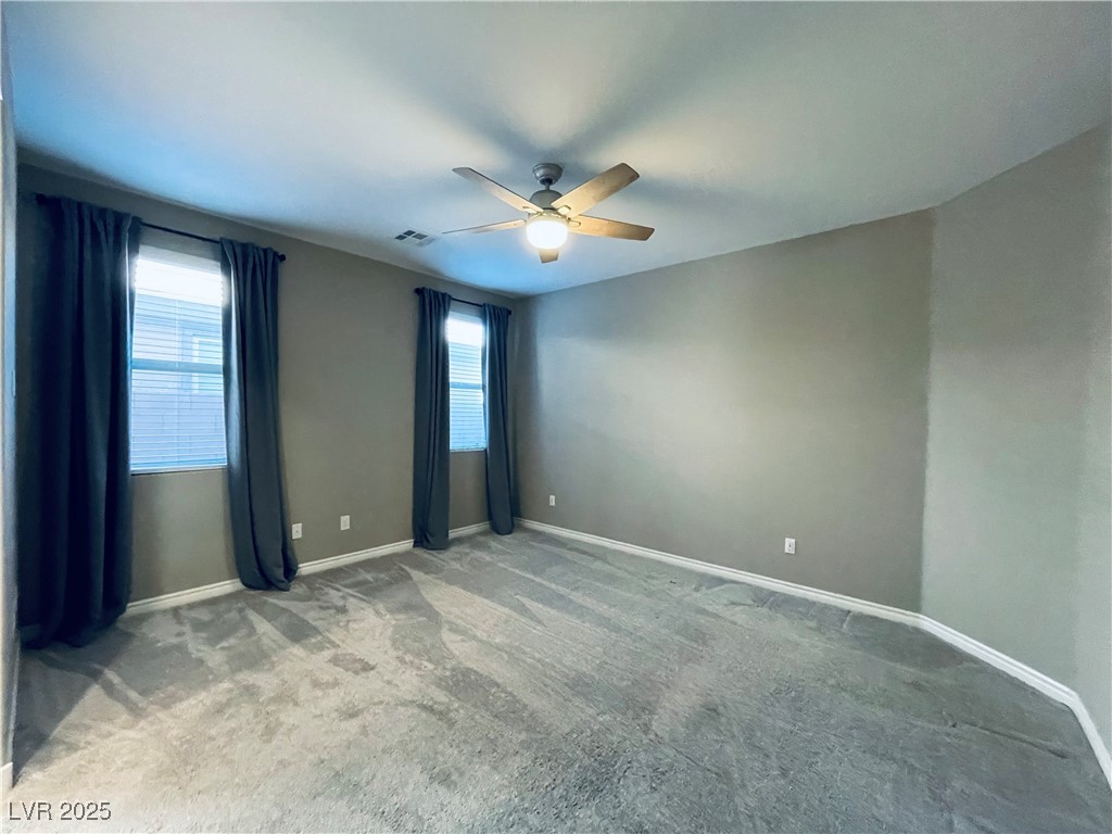 930 Bayberry Ridge Street Henderson, NV 89052 - Photo 26 of 40 Unfurnished room with light colored carpet, plenty of natural light, and ceiling fan