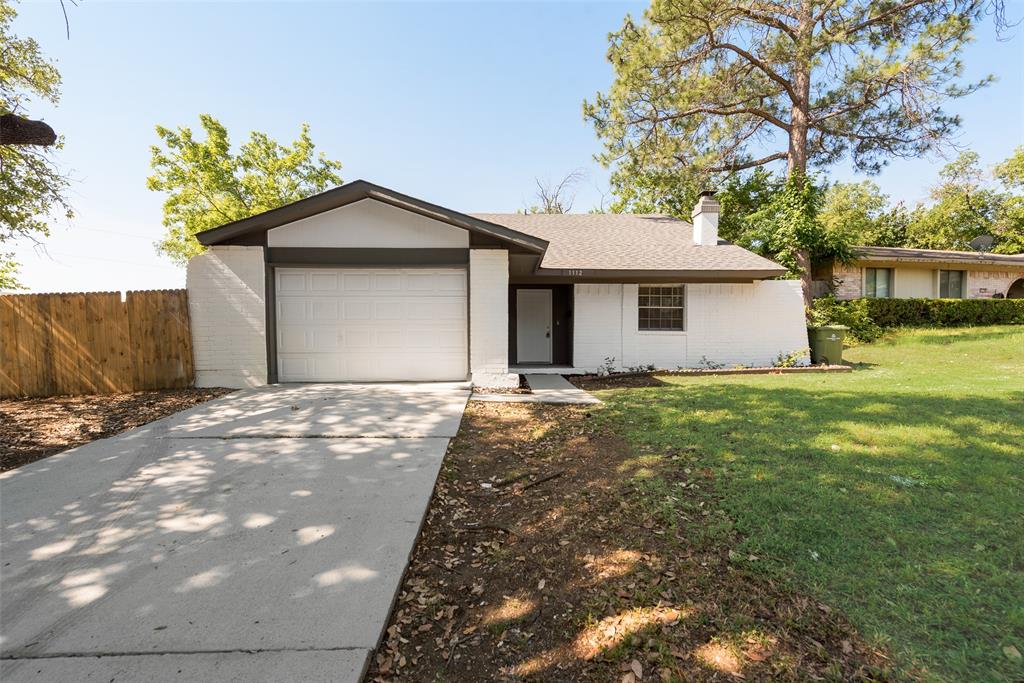 1112 Terrace Trail Carrollton, TX 75006 - Photo 1 of 20 a front view of a house with a yard and garage