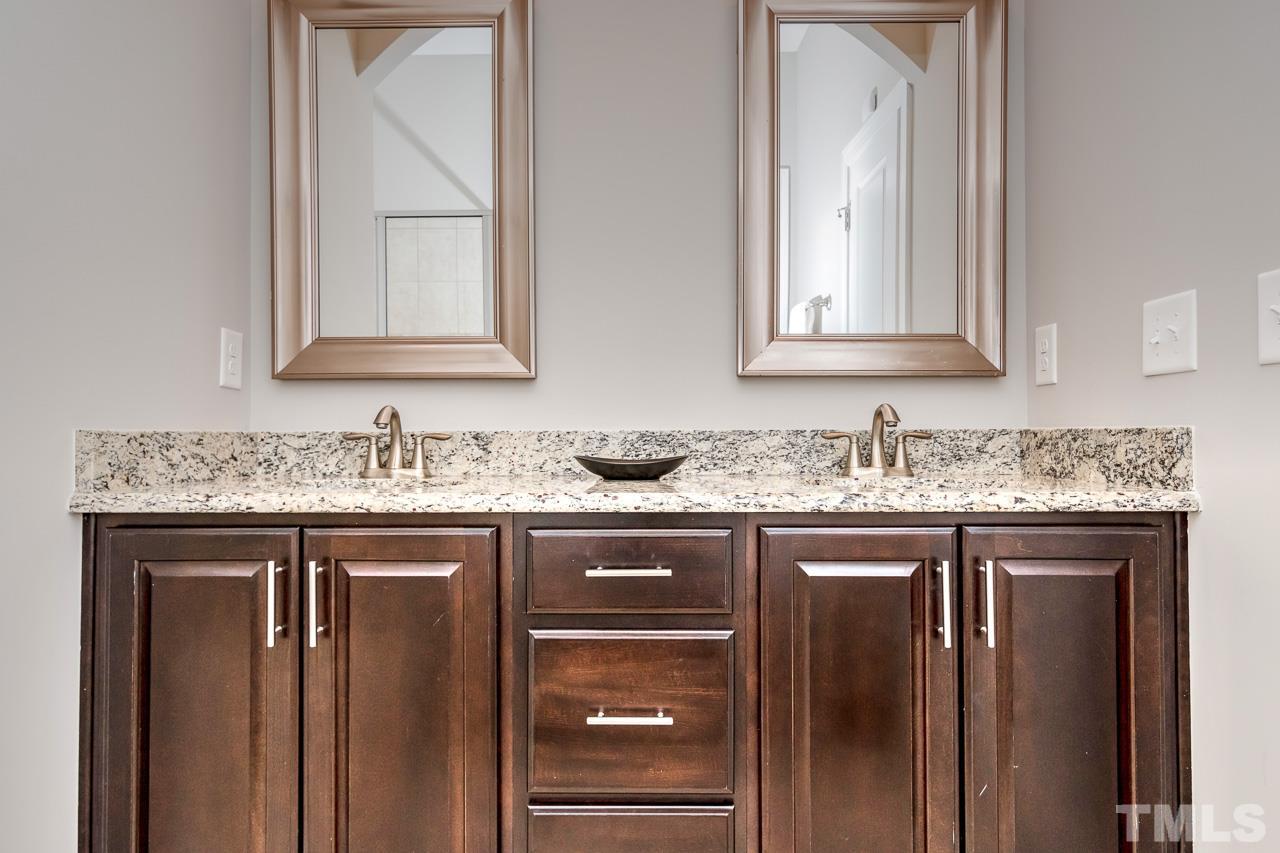 1409 Rodessa Run Raleigh, NC 27607 - Photo 11 of 25 a bathroom with a granite countertop sink and a mirror