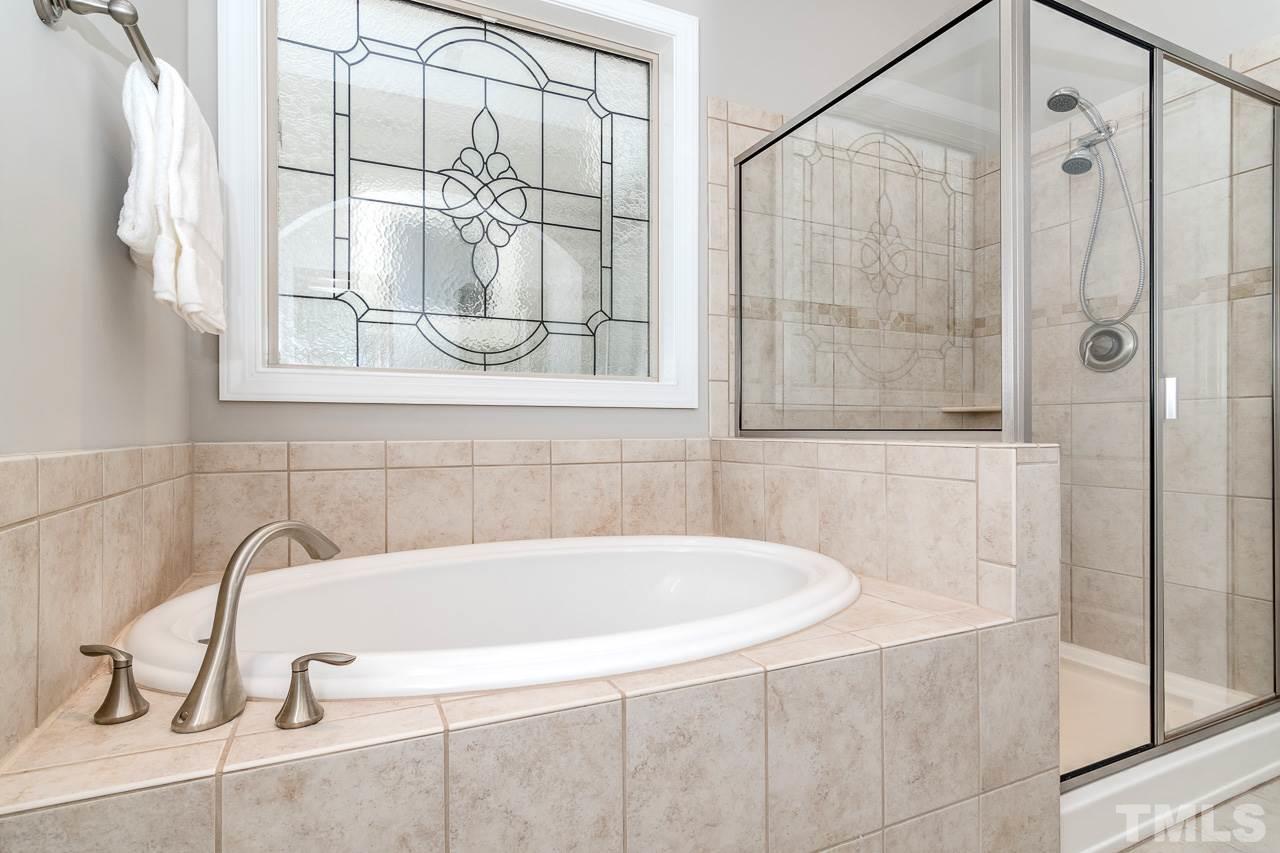 1409 Rodessa Run Raleigh, NC 27607 - Photo 12 of 25 a bathroom with a bathtub and shower