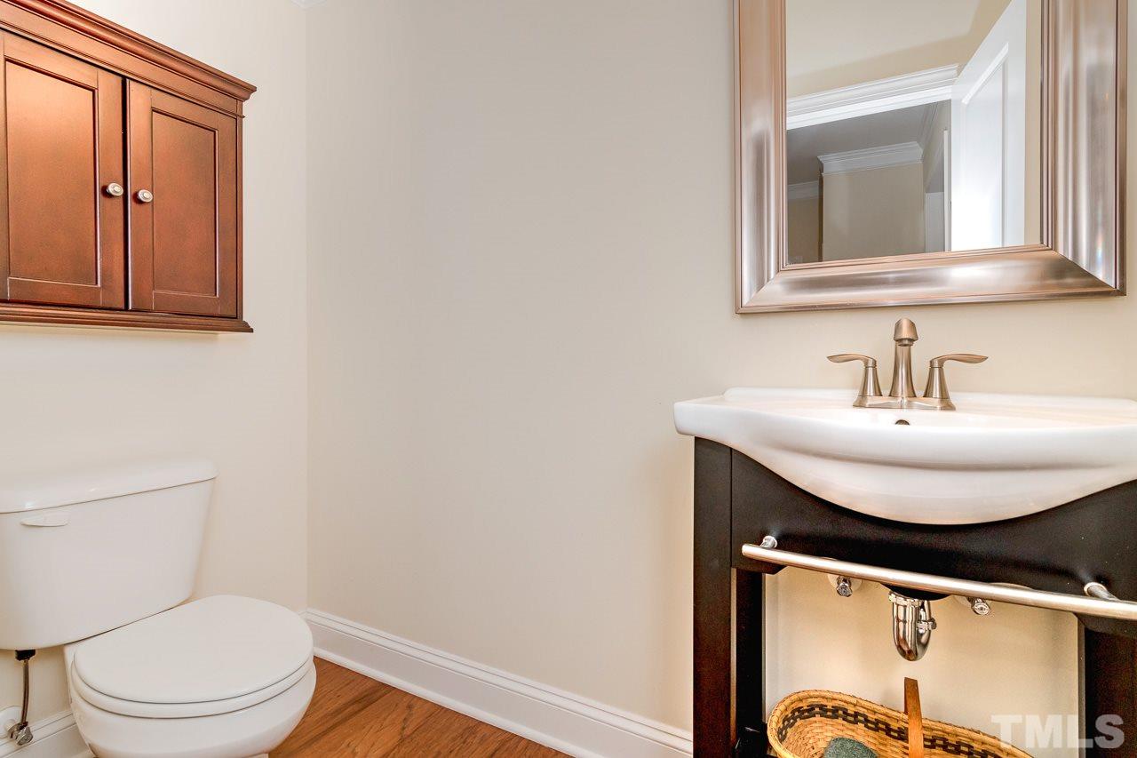 1409 Rodessa Run Raleigh, NC 27607 - Photo 14 of 25 a bathroom with a toilet a sink and mirror