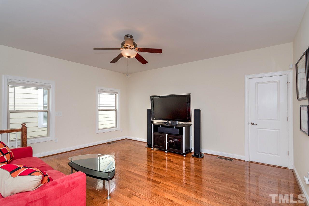 1409 Rodessa Run Raleigh, NC 27607 - Photo 16 of 25 a living room with furniture and a flat screen tv