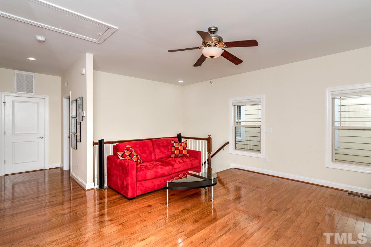 1409 Rodessa Run Raleigh, NC 27607 - Photo 17 of 25 a living room with furniture and wooden floor