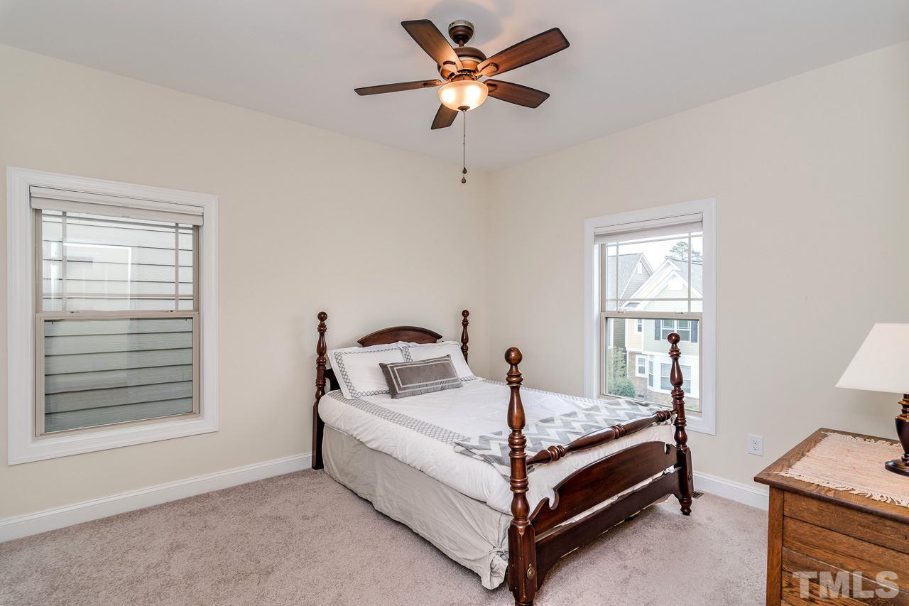 1409 Rodessa Run Raleigh, NC 27607 - Photo 20 of 25 a bed sitting in a bedroom next to a window