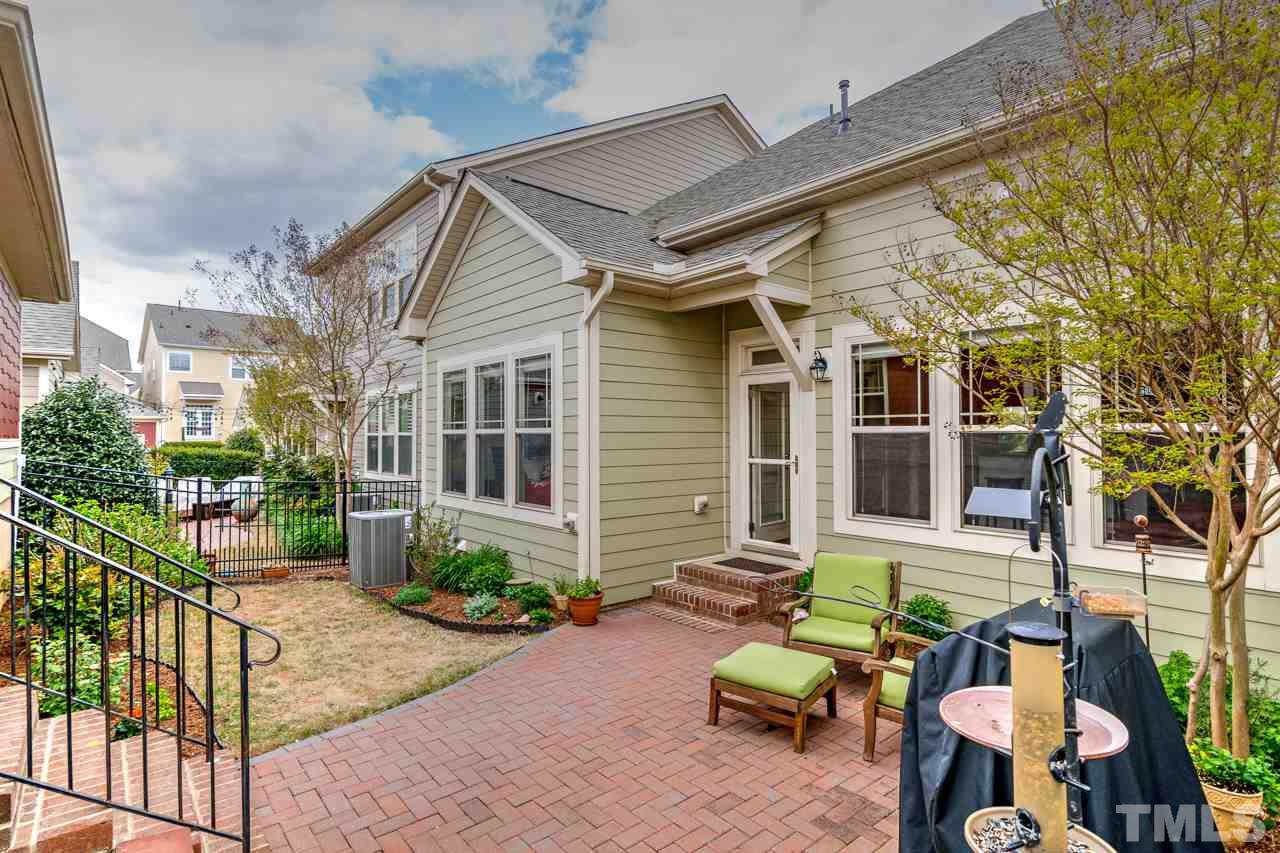 1409 Rodessa Run Raleigh, NC 27607 - Photo 21 of 25 front view of a house with a chairs and table in a patio