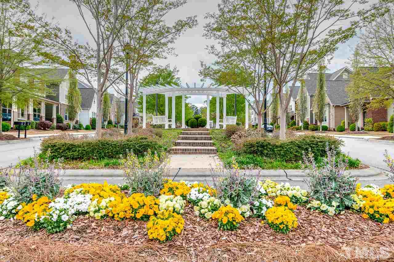 1409 Rodessa Run Raleigh, NC 27607 - Photo 25 of 25 a front view of a house with a yard and fountain in middle