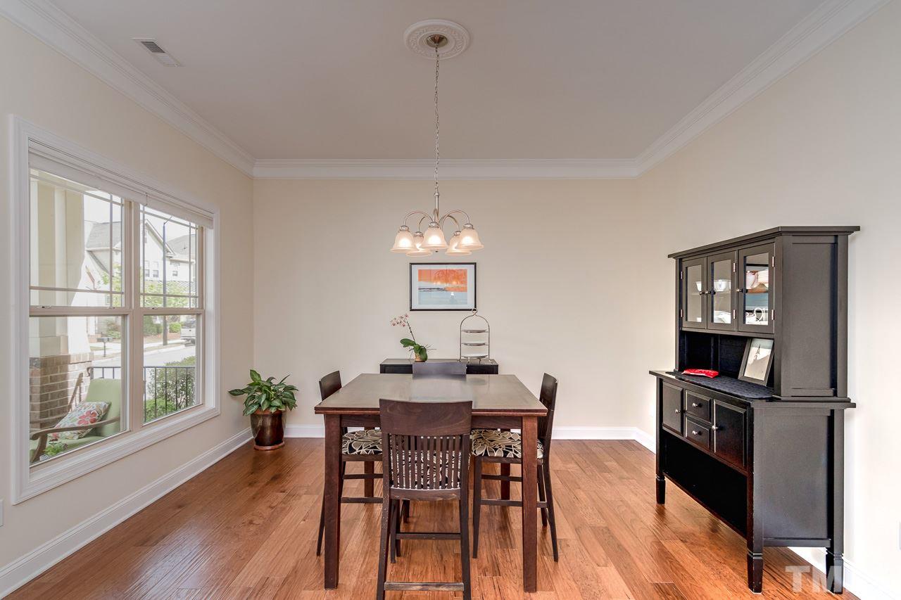 1409 Rodessa Run Raleigh, NC 27607 - Photo 5 of 25 a view of a dining room with furniture window and wooden floor