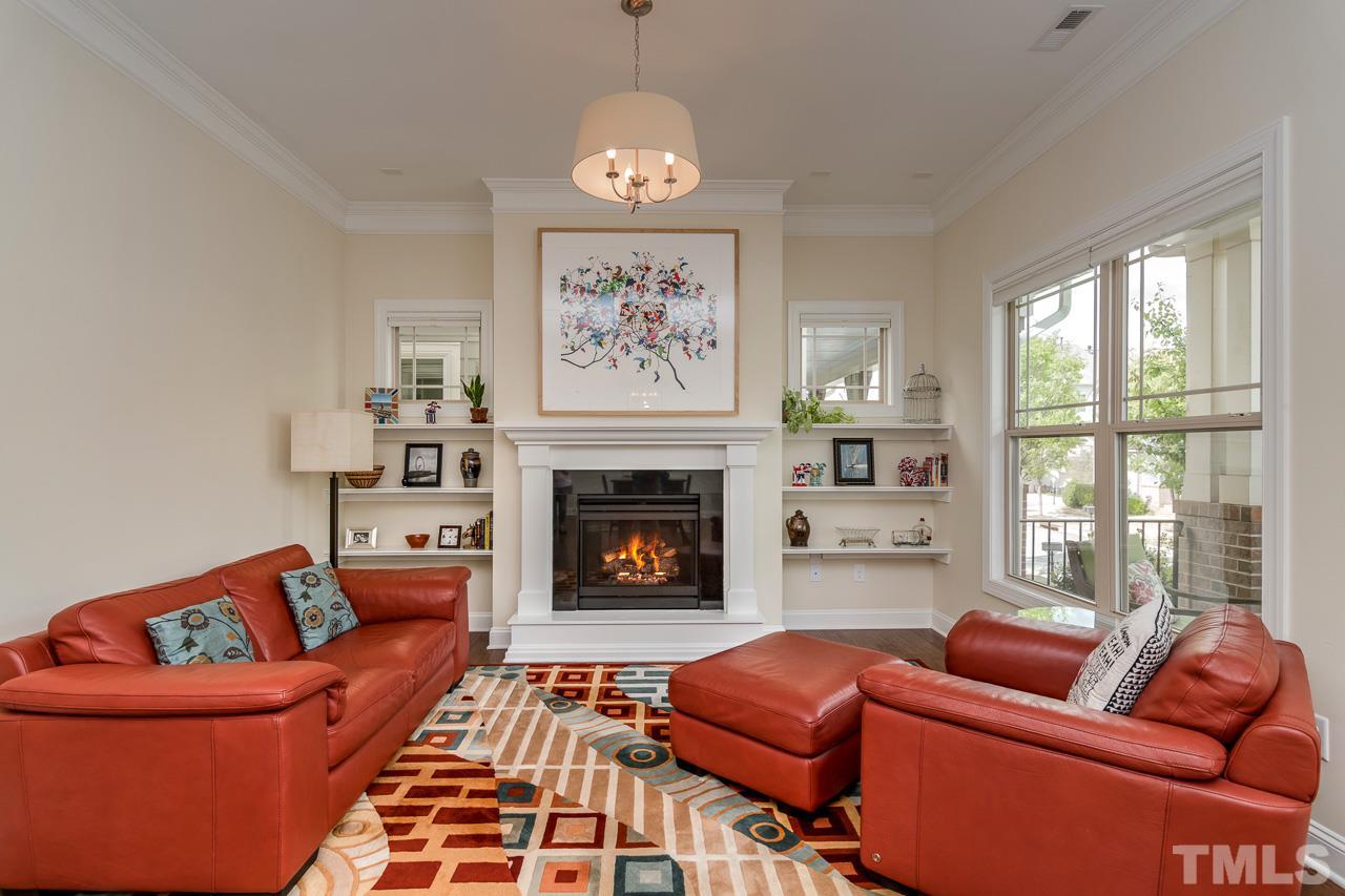 1409 Rodessa Run Raleigh, NC 27607 - Photo 6 of 25 a living room with furniture a fireplace and a large window