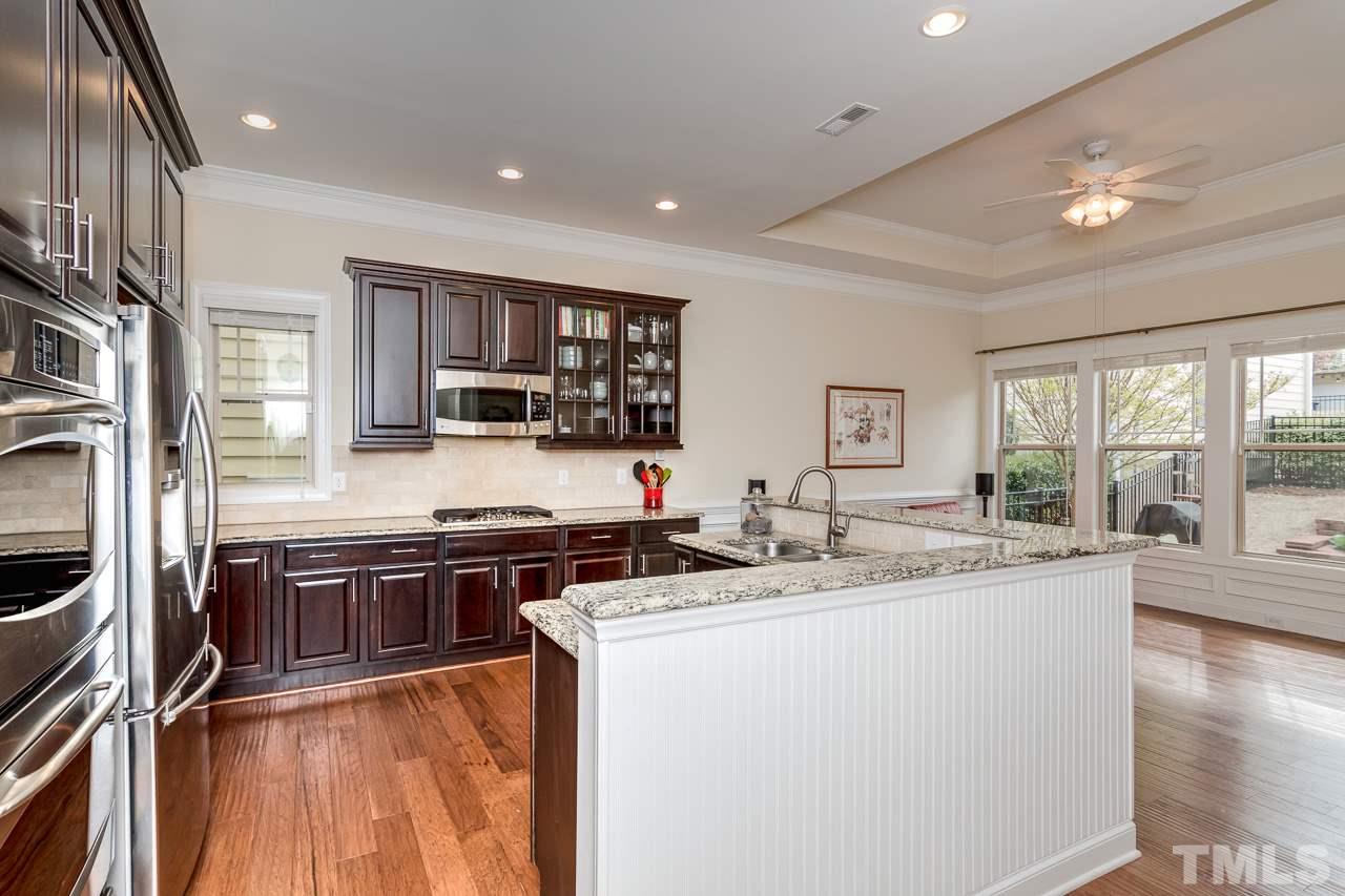 1409 Rodessa Run Raleigh, NC 27607 - Photo 9 of 25 a large kitchen with stainless steel appliances granite countertop a stove and a sink