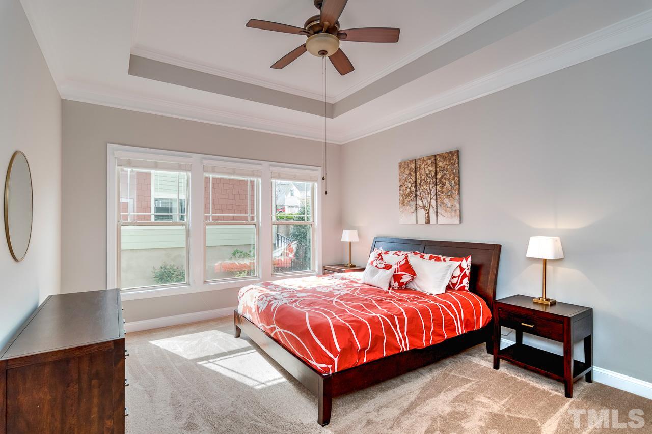 1409 Rodessa Run Raleigh, NC 27607 - Photo 10 of 25 a bedroom with a bed lamp and window