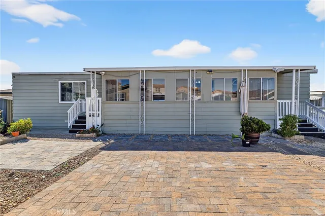 a kitchen with stainless steel appliances granite countertop a sink a stove and white cabinets