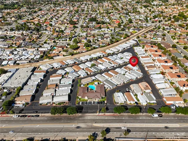 a view of an empty room and a chandelier fan