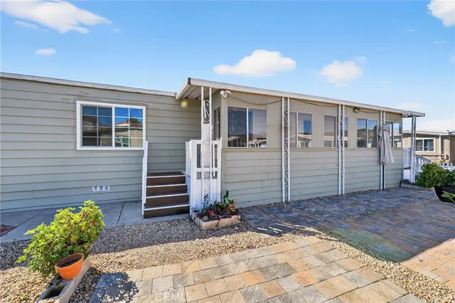 an empty room with closet and a chandelier fan