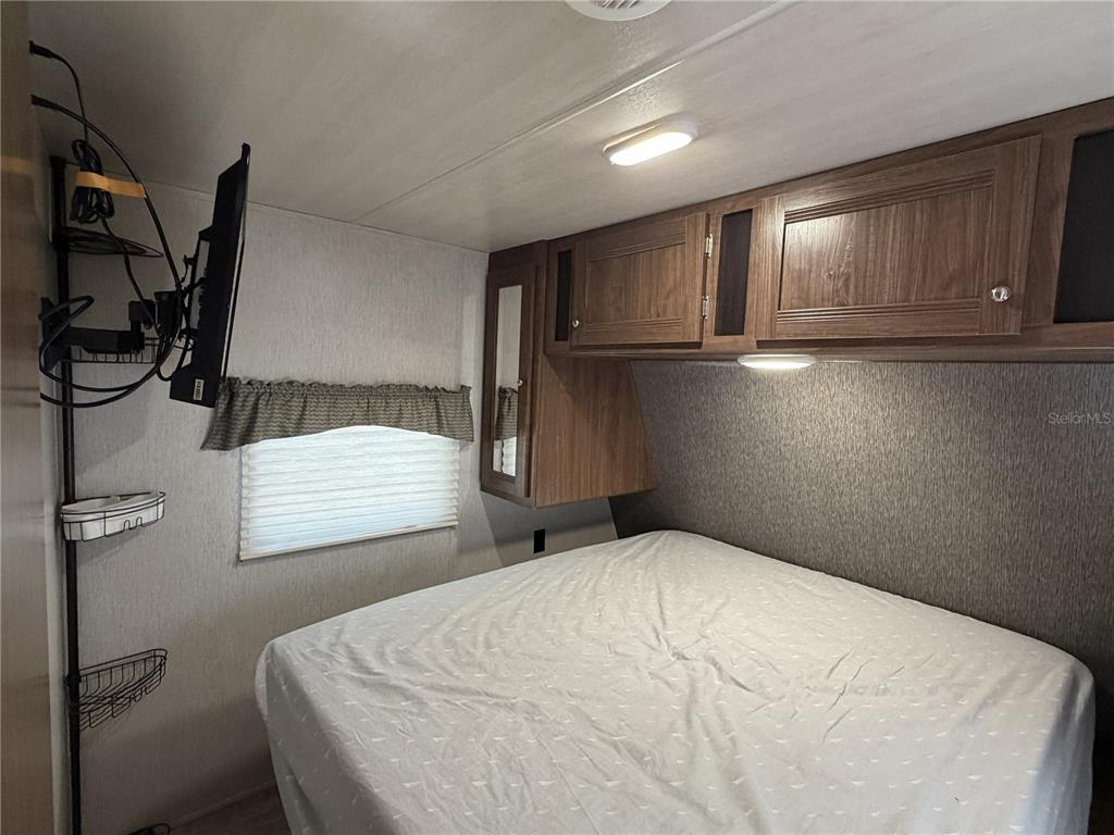 3000 Clarcona Road, Unit 743 Apopka, FL 32703 - Photo 32 of 54 a bedroom with a bed and cabinets