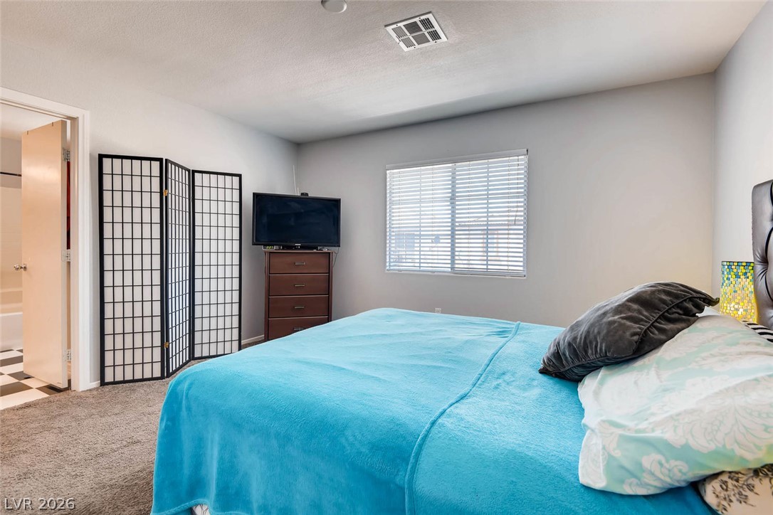 10451 Processor Court Las Vegas, NV 89129 - Photo 16 of 28 A window-filled room with plush carpeting, offering a peaceful retreat.