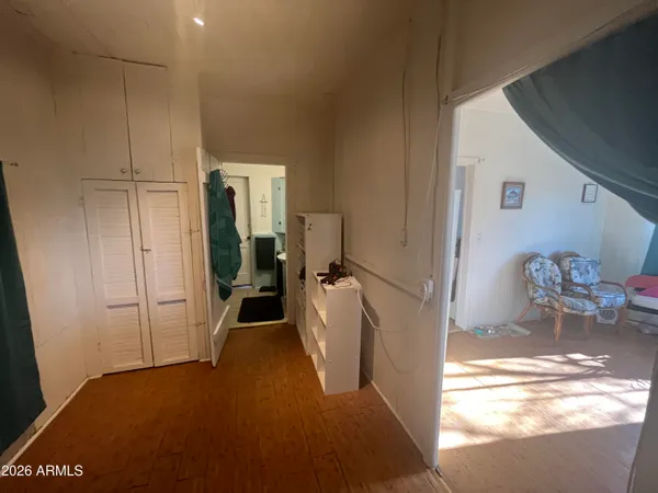 a view of a hallway to a livingroom with furniture