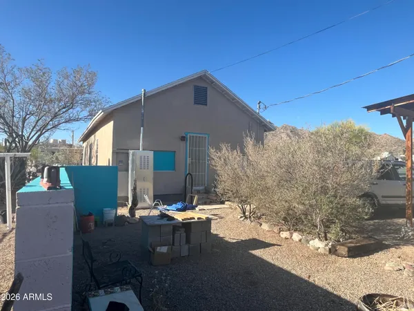 a view of backyard of house with seating space