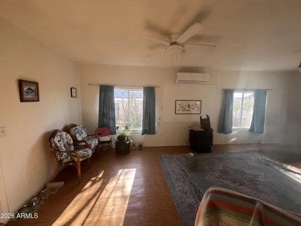 a living room with furniture chandelier and a window