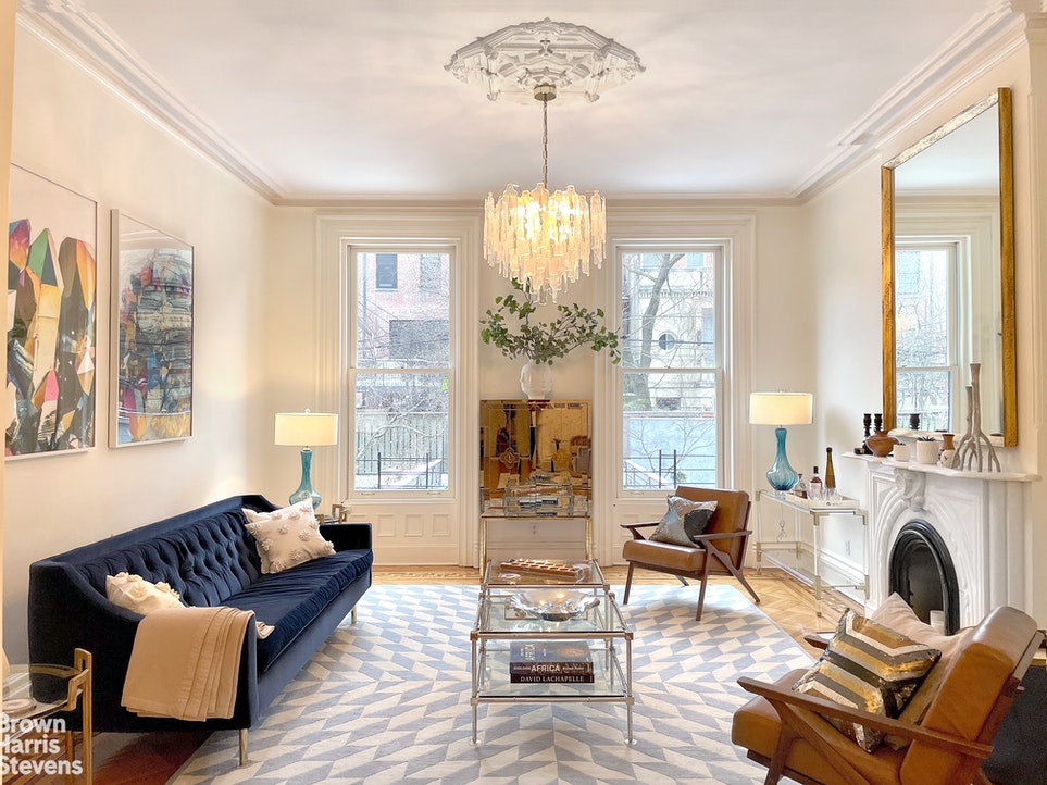 a living room with furniture large window and flat screen tv