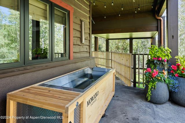 a view of a porch with furniture and a yard