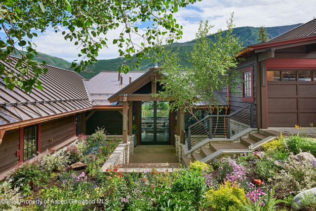a living room with furniture a flat screen tv and a large window