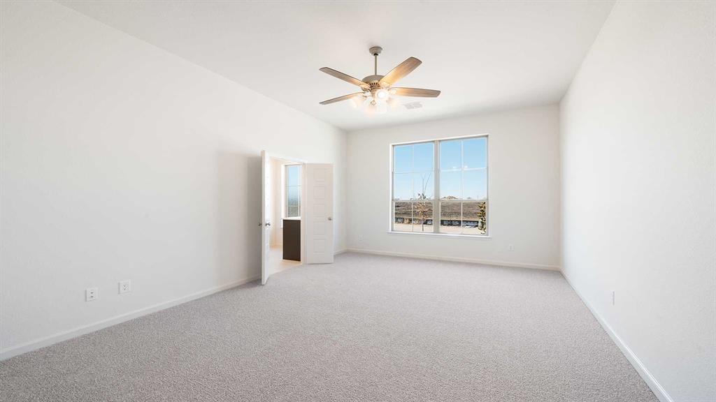 6108 Vester Trail Fate, TX 75087 - Photo 14 of 21 an empty room with a window and a ceiling fan