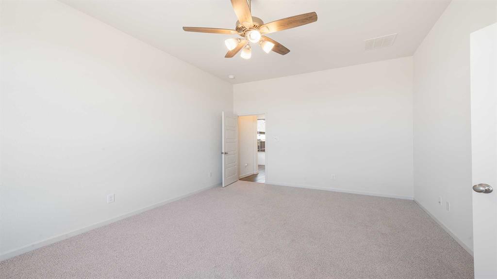 6108 Vester Trail Fate, TX 75087 - Photo 15 of 21 an empty room with a fan & a ceiling fan