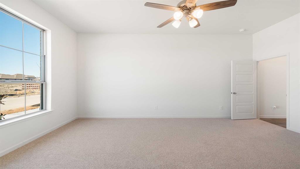 6108 Vester Trail Fate, TX 75087 - Photo 6 of 21 an empty room with a window and a fan