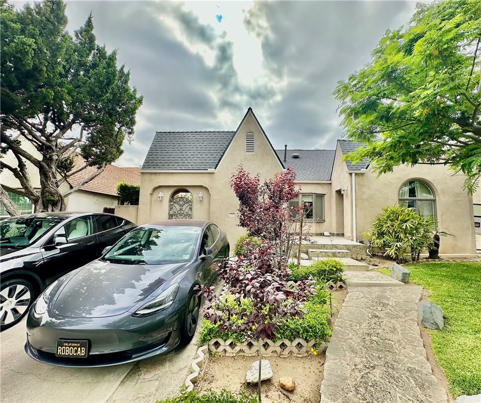 a front view of a house with garden