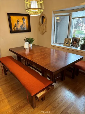 a room with wooden floor and pool table