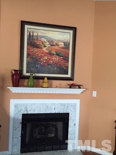 4708 Silverdene Street Raleigh, NC 27616 - Photo 12 of 14 a view of fireplace with wooden floor