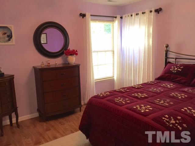 4708 Silverdene Street Raleigh, NC 27616 - Photo 13 of 14 a bedroom with a bed and a window