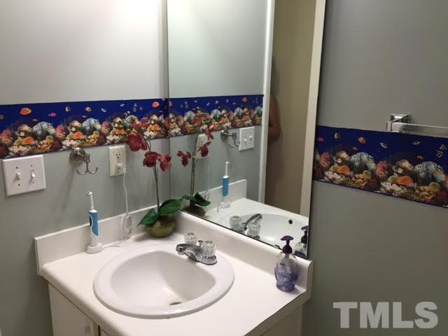 4708 Silverdene Street Raleigh, NC 27616 - Photo 14 of 14 a bathroom with a sink and a mirror