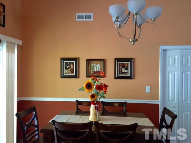 4708 Silverdene Street Raleigh, NC 27616 - Photo 4 of 14 a view of a dining room with furniture and chandelier