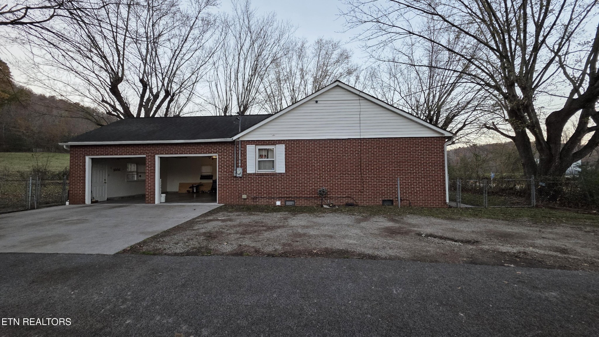 992 Walden Ridge Lane Caryville, TN 37714 - Photo 19 of 58 a front view of a house with a yard and garage