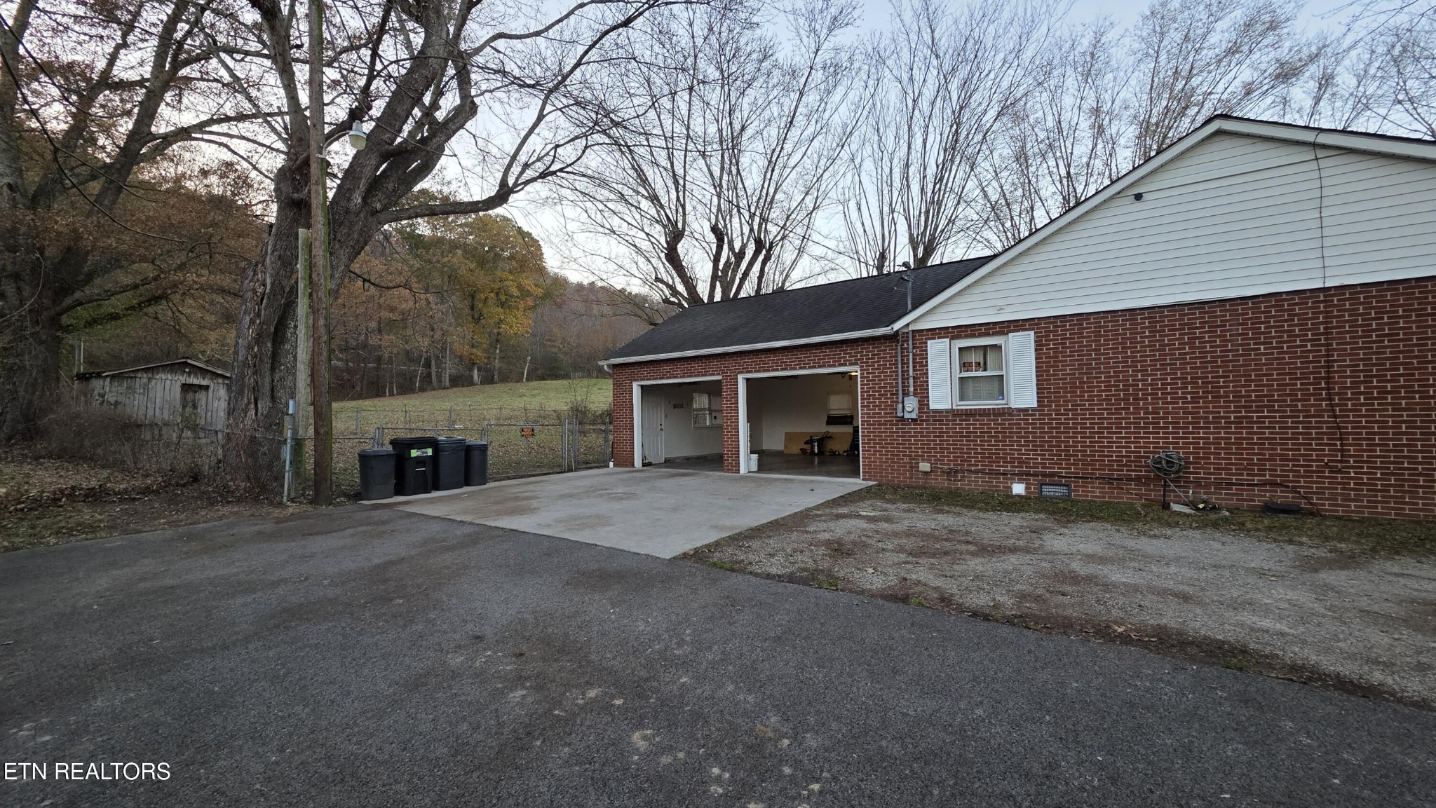 992 Walden Ridge Lane Caryville, TN 37714 - Photo 20 of 58 a front view of a house with a yard and garage
