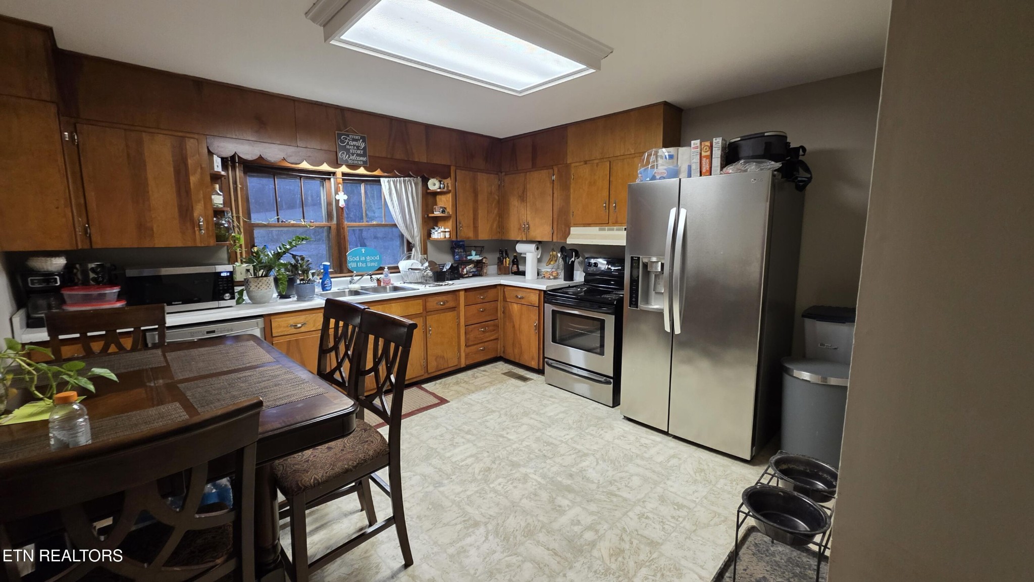 992 Walden Ridge Lane Caryville, TN 37714 - Photo 34 of 58 a kitchen with granite countertop a sink appliances a counter space and a refrigerator