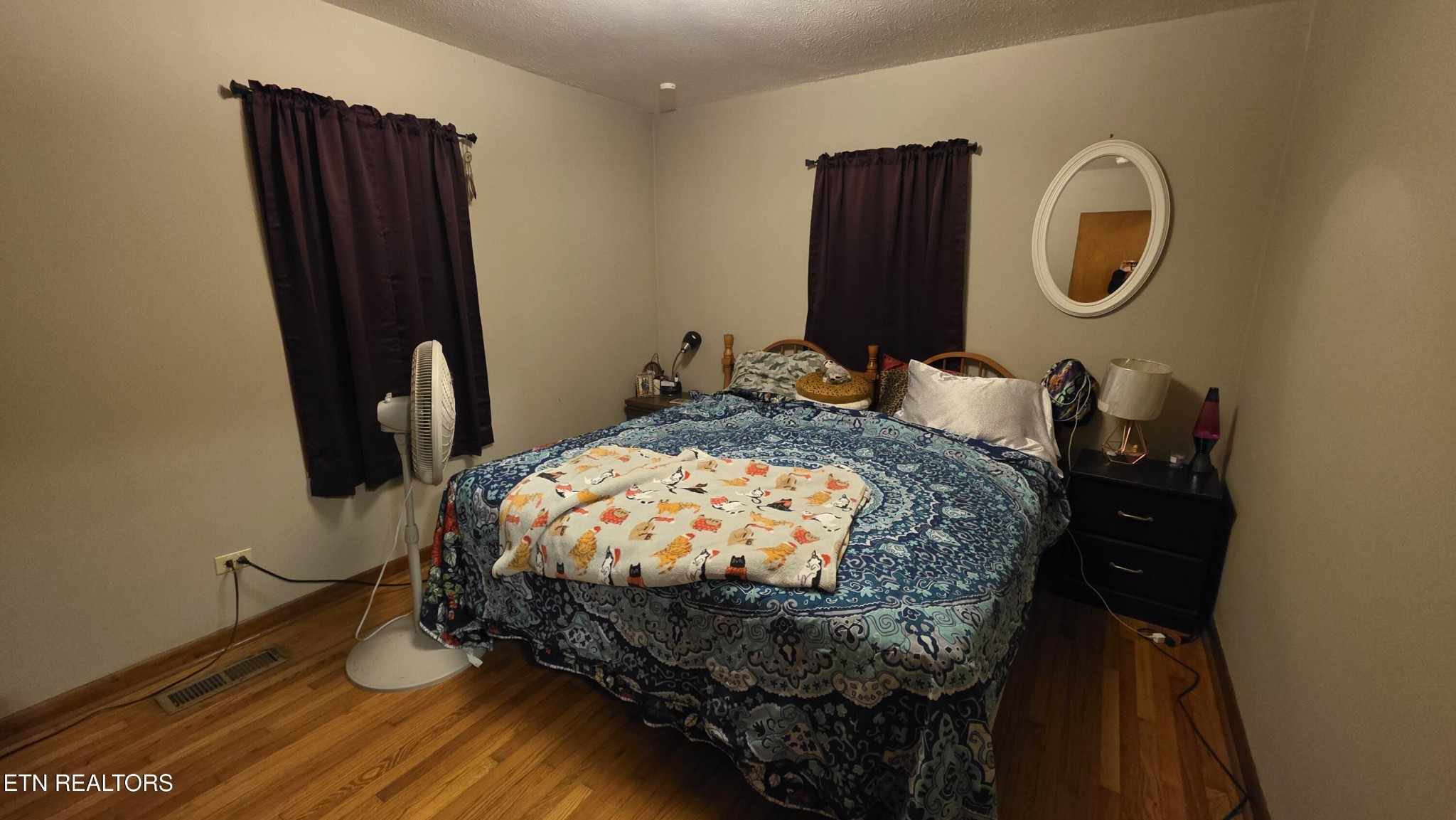 992 Walden Ridge Lane Caryville, TN 37714 - Photo 51 of 58 a bed sitting in a bedroom next to a window with wooden floor