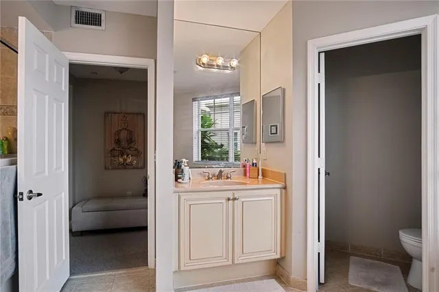 a bathroom with a sink toilet a mirror and shower