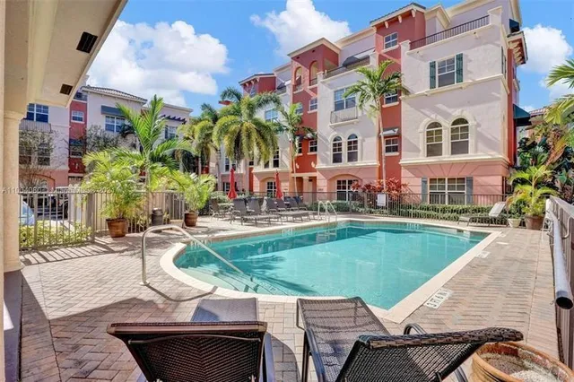 a view of a patio with couches table and chairs and potted plants