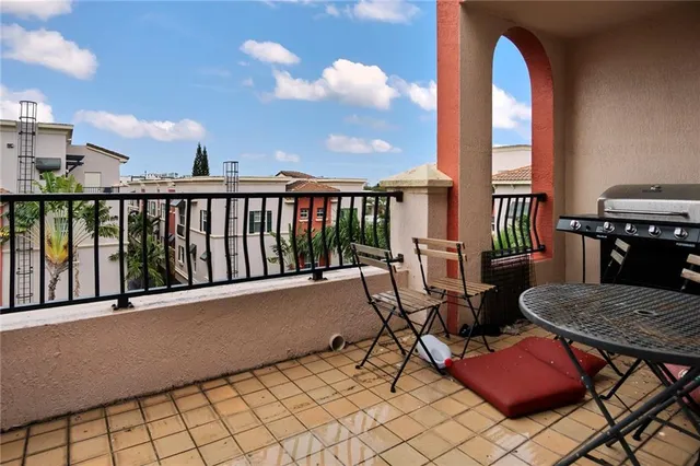 a front view of a building with street and trees